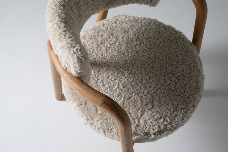 closeup on chair of wood and sheepskin